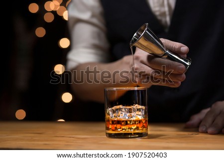 Bartender Serve Whiskey, on wood bar,  Royalty-Free Stock Photo #1907520403