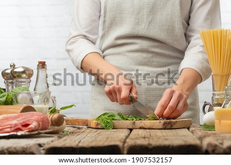 The chef is preparing a salad or dish, the chef cuts the basil leaves. Ingredients Cooking  Recipe Book