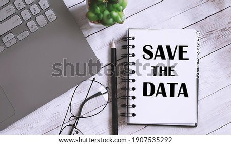 Save The Data text on notebook with office background