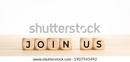 Join us word on wooden blocks on wood table. Copy space. White background