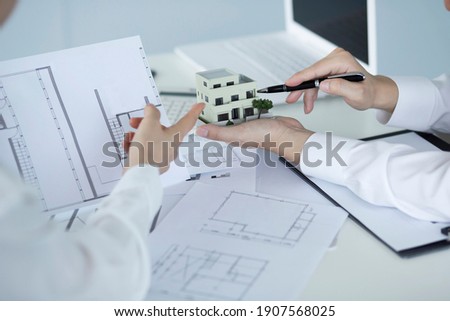 Business people meeting with model house Royalty-Free Stock Photo #1907568025