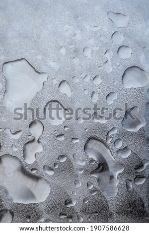 Close up view of water rain drops on a metal surface