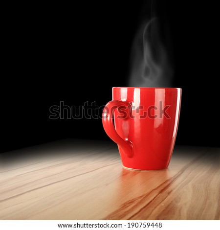 red mug on desk and black interior 
