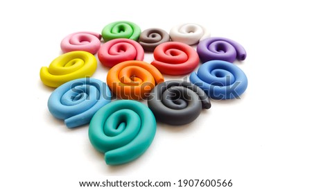 A cute heart sculpture made from plasticine of various colors.
isolated on white background.(Valentine's Day)