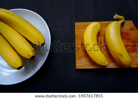 Banana inside wood isolated on black background.