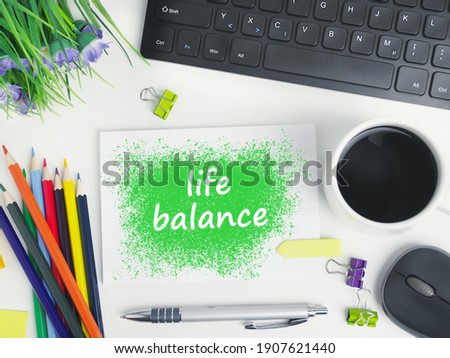 work life balance word cloud handwriting on a notebook with a cup of coffee on office workspace. organizer mockup concept for blog or header image with space for text or copy space