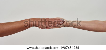 Close up of two hands put on each other, palm to palm, gesture of assistance and care isolated over light background. Web Banner