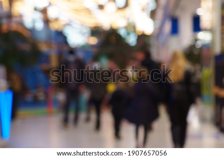 Blurred background. A group of people in a shopping center.