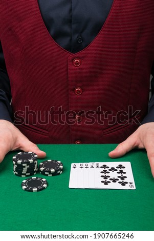 working as a croupier at a green poker table