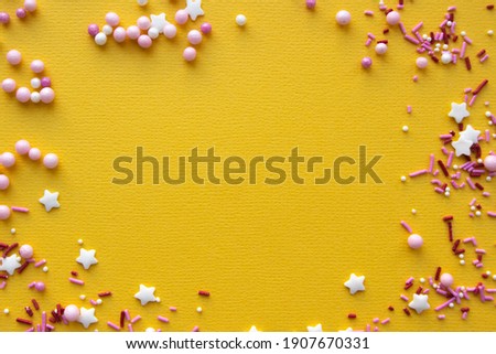 Decorations for pastry on yellow background