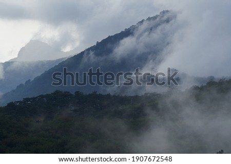 Mountain landscape with thick clouds after rain.