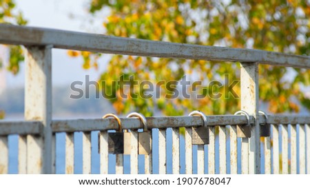 Wedding padlocks hanging on railing of bridge. Shallow depth of field.