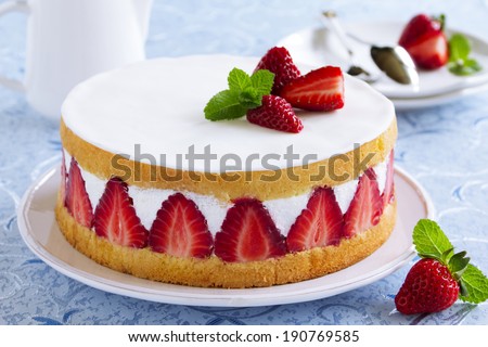 Sponge cake with strawberries and vanilla cream. Royalty-Free Stock Photo #190769585