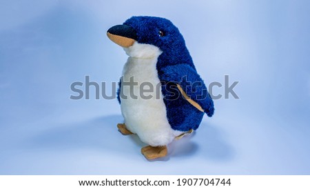 penquin doll walk on blue background