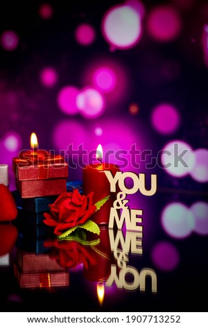 Gift boxes, a red rose and candles stand on a mirrored surface against a blurred bokeh background. Holiday. Valentine's Day. International Women's Day. Anniversary. Wedding. 