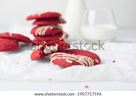 Red velvet cookies on a white plate and milk. Concept: breakfast, romance, valentines day. Copy space. Horizontal