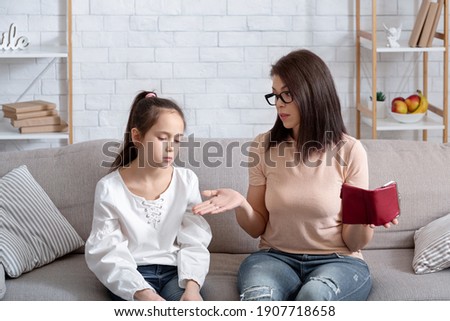 Family financial problems during coronavirus pandemic. Unhappy mother and her daughter with empty wallet at home. Mom and kid suffering from economic crisis, having no money at times of covid lockdown Royalty-Free Stock Photo #1907718658