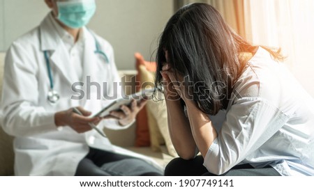 Panic attack menopause woman, stressful depressed PTSD patient with anxiety disorder having consultation psychotherapy treatment session in doctor clinic or psychologist counselor office  Royalty-Free Stock Photo #1907749141