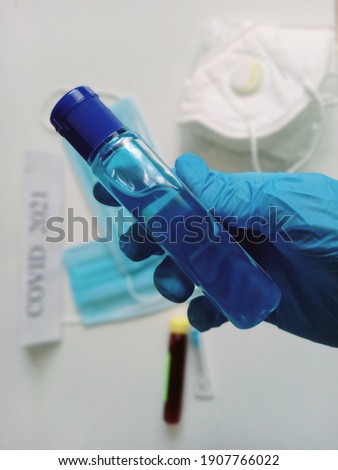 Blue sanitizer with gloves and protective masks