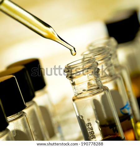 Laboratory research, dropping liquid to test tube  Royalty-Free Stock Photo #190778288