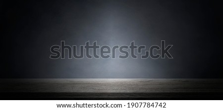 Empty wooden table with smoke float up on dark background,used as a studio background wall to display your products.