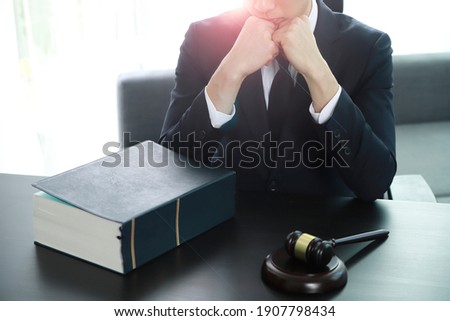 Serious pensive lawyer working at desk in office
