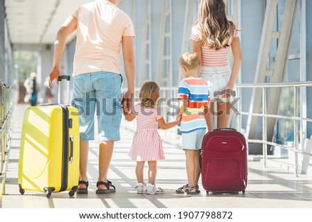 Happy family in airport departures. People in terminal preparing for the vacation Royalty-Free Stock Photo #1907798872
