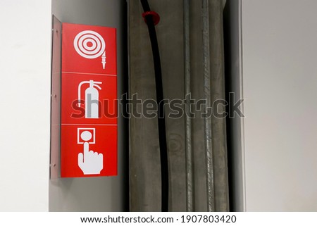 Steel sign board of fire safety water hoses, fire estinguish and emergency switch.
