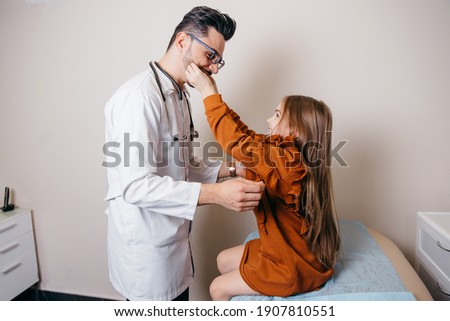 Arab or Turkish pediatrician examining a little girl