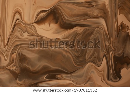 Abstract caramel background.Make up concept.Beautiful stains of liquid nail laquers.Fluid art,pour painting technique.Good as digital decor or wallpaper for phone,copy space.Horizontal photography.