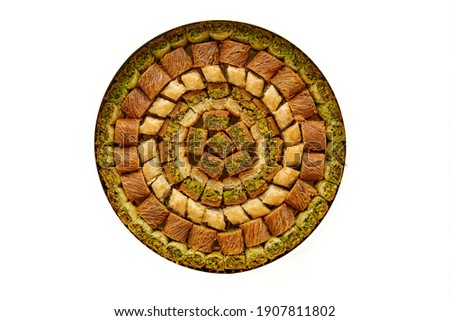 Traditional turkish, arabic sweets baklava assortment with pistachio isolated on white. Top view, copy space