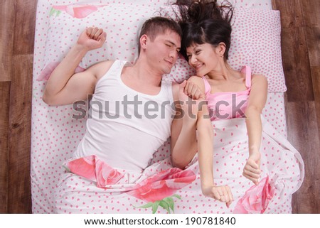 Young couple waking up in the bed