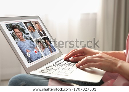 Woman visiting dating site via laptop indoors, closeup
