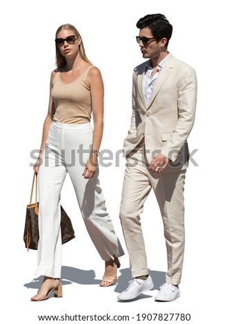 Elegant couple in white summer clothes walking together, isolated on white background Royalty-Free Stock Photo #1907827780