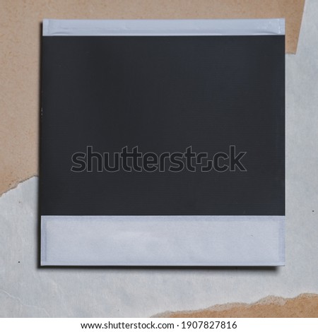 Blank photo frame on brown background as template for design. Photo card with space for your logo or text. Royalty-Free Stock Photo #1907827816