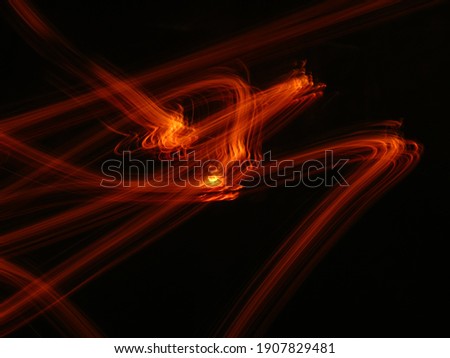 Orange, red, flame, fire abstract Neon light random lines on black background