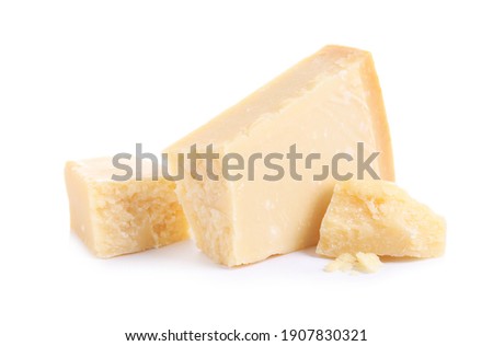 Pieces of delicious parmesan cheese on white background Royalty-Free Stock Photo #1907830321