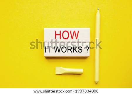 HOW IT WORKS text on the cubes. yellow pen on a yellow background. a bright solution for business, financial, marketing concept. Copy space