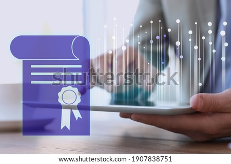 Online learning concept. Diploma on foreground and man using tablet, closeup