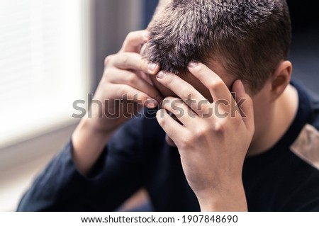 Shame, regret or despair. Sad lonely young man with depression or stress. Ashamed person in sorrow after mistake. Upset victim of discrimination or bullying with trauma. Guy with solitude or anxiety. Royalty-Free Stock Photo #1907848690