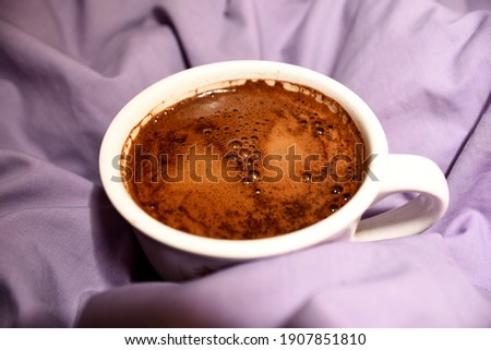 Coffee mug on the background of the wrinkled cloth. The concept of love and valentine's day 