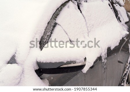 pictured car littered with large snowdrifts