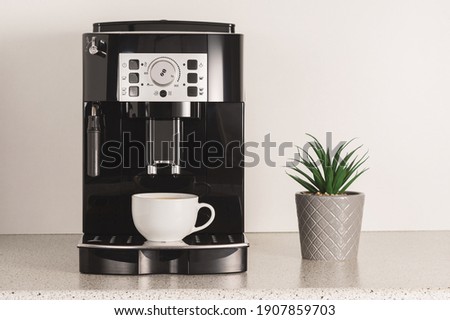 Modern espresso coffee machine with a cup in kitchen. Royalty-Free Stock Photo #1907859703