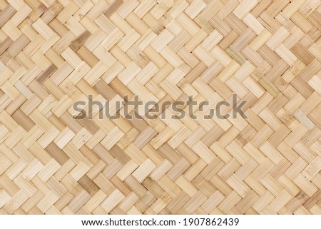 Traditional bamboo handcraft weaving pattern in Thailand. Thai wicker rattan texture pattern. Local handmade. Royalty-Free Stock Photo #1907862439
