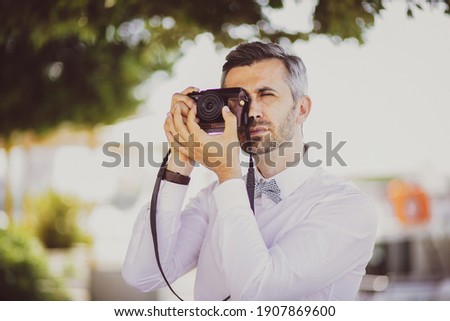A photographer shooting with a retro camera