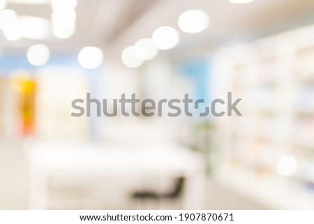 Blurred image for background of many books on bookshelf in library.
