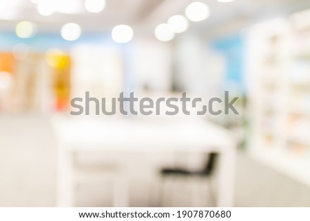 Blurred image for background of many books on bookshelf in library.