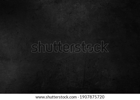 Old black background. Concrete wall texture. Dark wallpaper. Blackboard for text