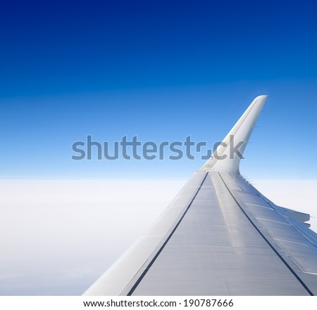 Wing of the plane. View from the porthole. Royalty-Free Stock Photo #190787666
