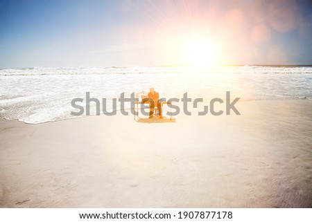 Businessman Sitting at an Office Desk at the Beach
